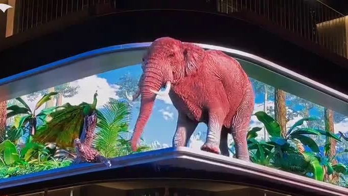 【昆明裸眼3D大象孔雀金丝猴】10月1日,云南昆明,一块裸眼3D户外屏幕上,出现了孔雀开屏